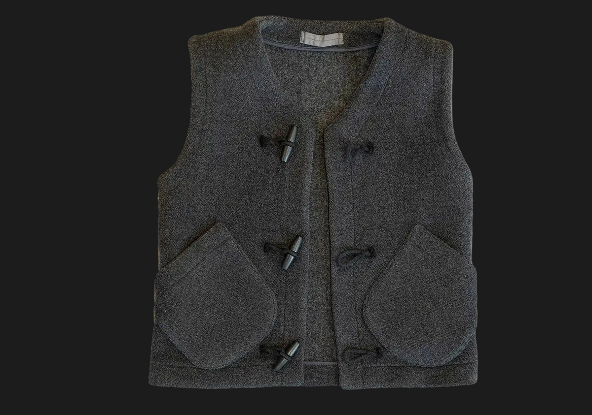 A dark gray teasel duffel wool vest with toggle closures and large front patch pockets, shown flat against a white background.