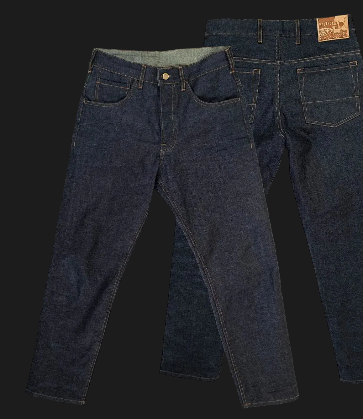 Two dark indigo denim jeans shown against a black background, with one front view and one back view overlapping. A brown leather brand patch is visible on the back waistband.